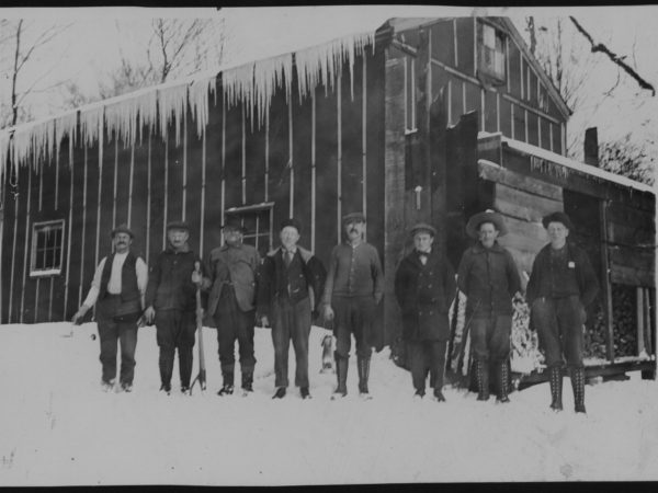 Workers outside a logging camp in Tupper Lake