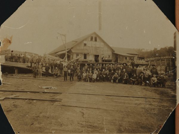 Workers outside a sawmill in Tupper Lake