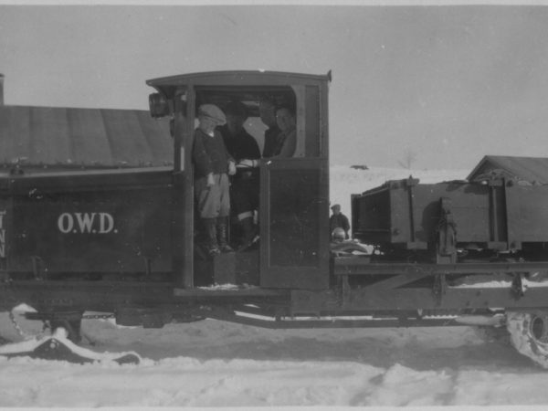 People posing on a Linn tractor in Tupper Lake