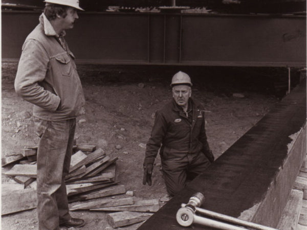 Workers talking by the steel framework used to move the Potsdam Depot in Potsdam, NY