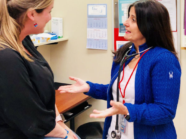 Dr. Kathleen Camelo speaks with a patient in Plattsburgh