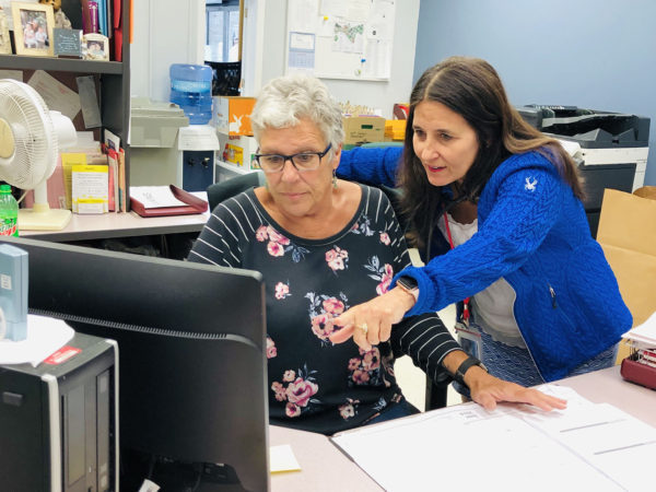 Dr. Kathleen Camelo Speaks with one of her staff in Plattsburgh