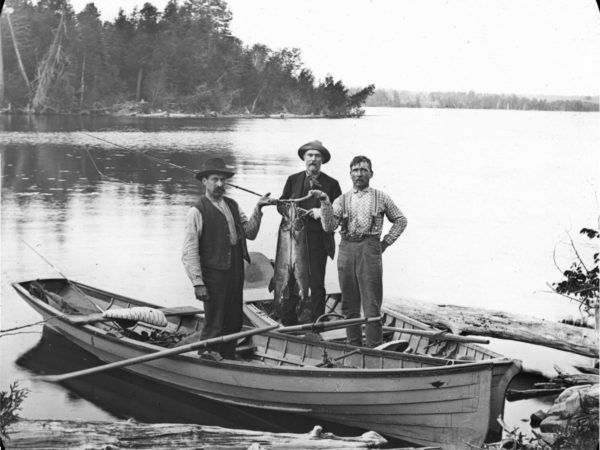 Three fishing guides with a catch in Alexandria Bay