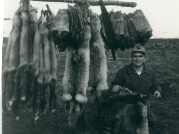 Trapper Roy Johnson with a rack of pelts in Philadelphia