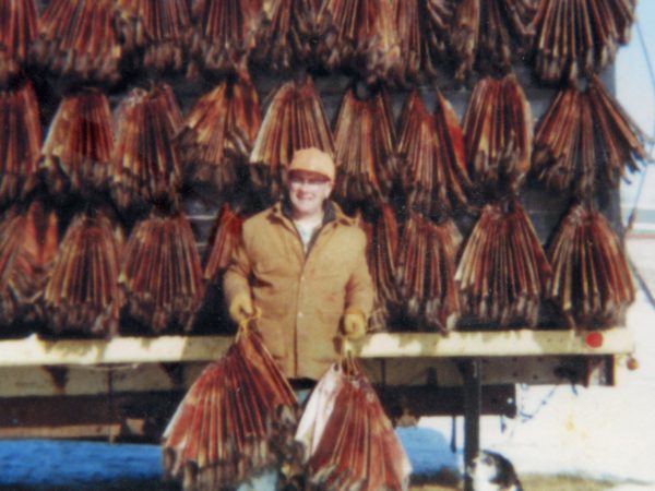 “Preacher-trapper” Roy Johnson with muskrat pelts in Philadelphia