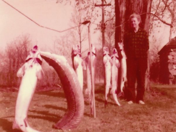 Posing with freshly-caught sturgeon in Alexandria Bay