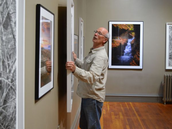 Artist Dan Keegan mounting a drawing in Elizabethtown