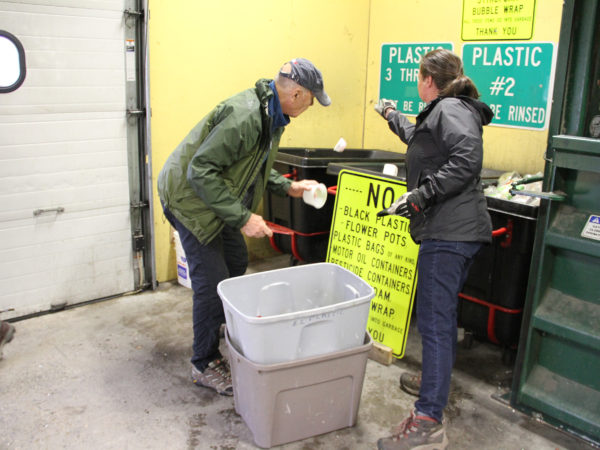 Jennifer Reid helping visitor to the recycling center in North Elba