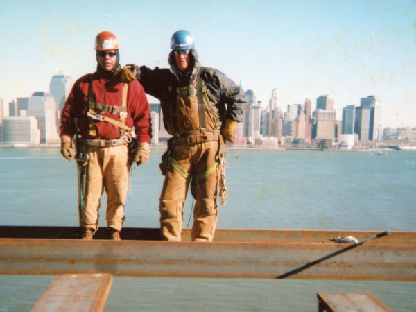 Mohawk ironworkers on a beam overlooking NYC