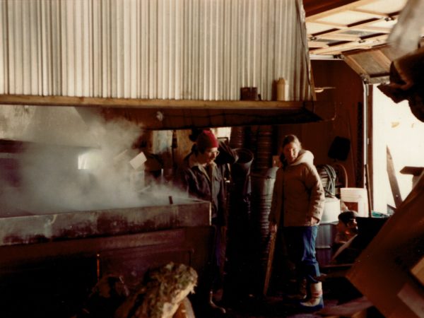 Eleanor and Allen Warren watch the evaporator in the Allen sugarhouse in Croghan