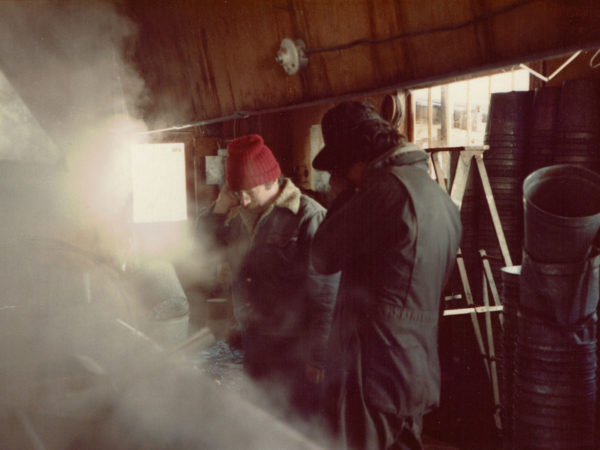 Warren Allen and Steve Zehr boil maple sap into syrup at the Allen sugarhouse.