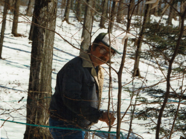 Warren Allen checking sap tubing in Croghan