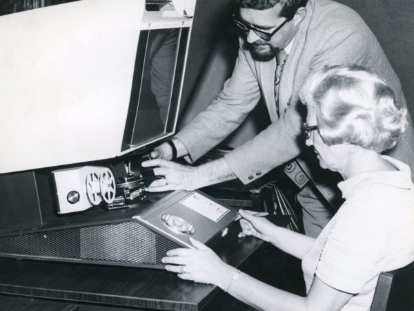 Reference assistants using a microfilm reader at Crandall Public Library in Glens Falls