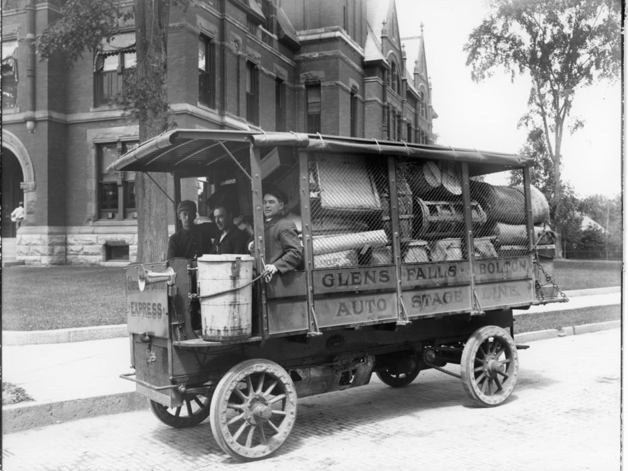 Bus driver loading luggage in Watertown