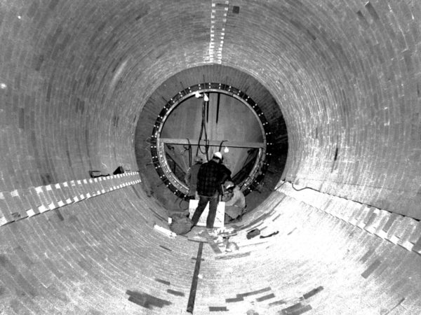 Men working in a large round structure in Glens Falls