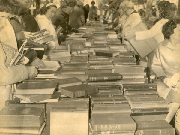 People peruse books at the Friends of Crandall Library book sale in Glens Falls