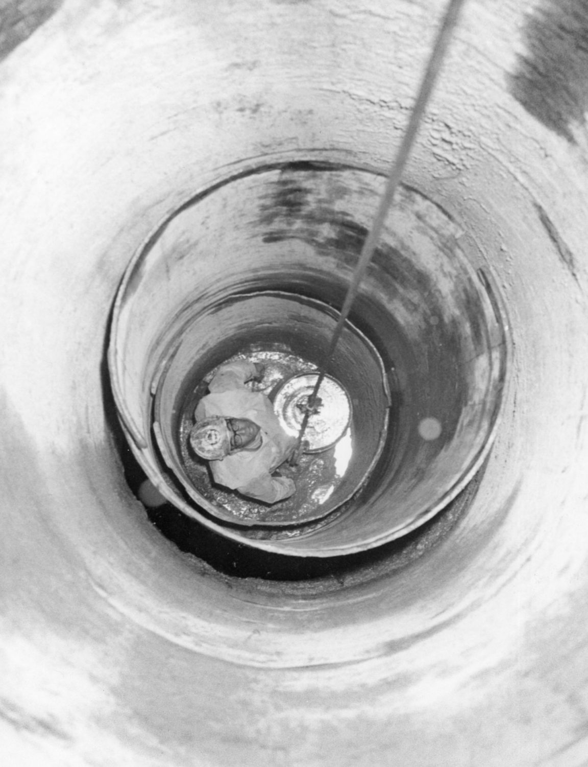 Worker Probing The Inside Of A Large Pipe In Glens Falls