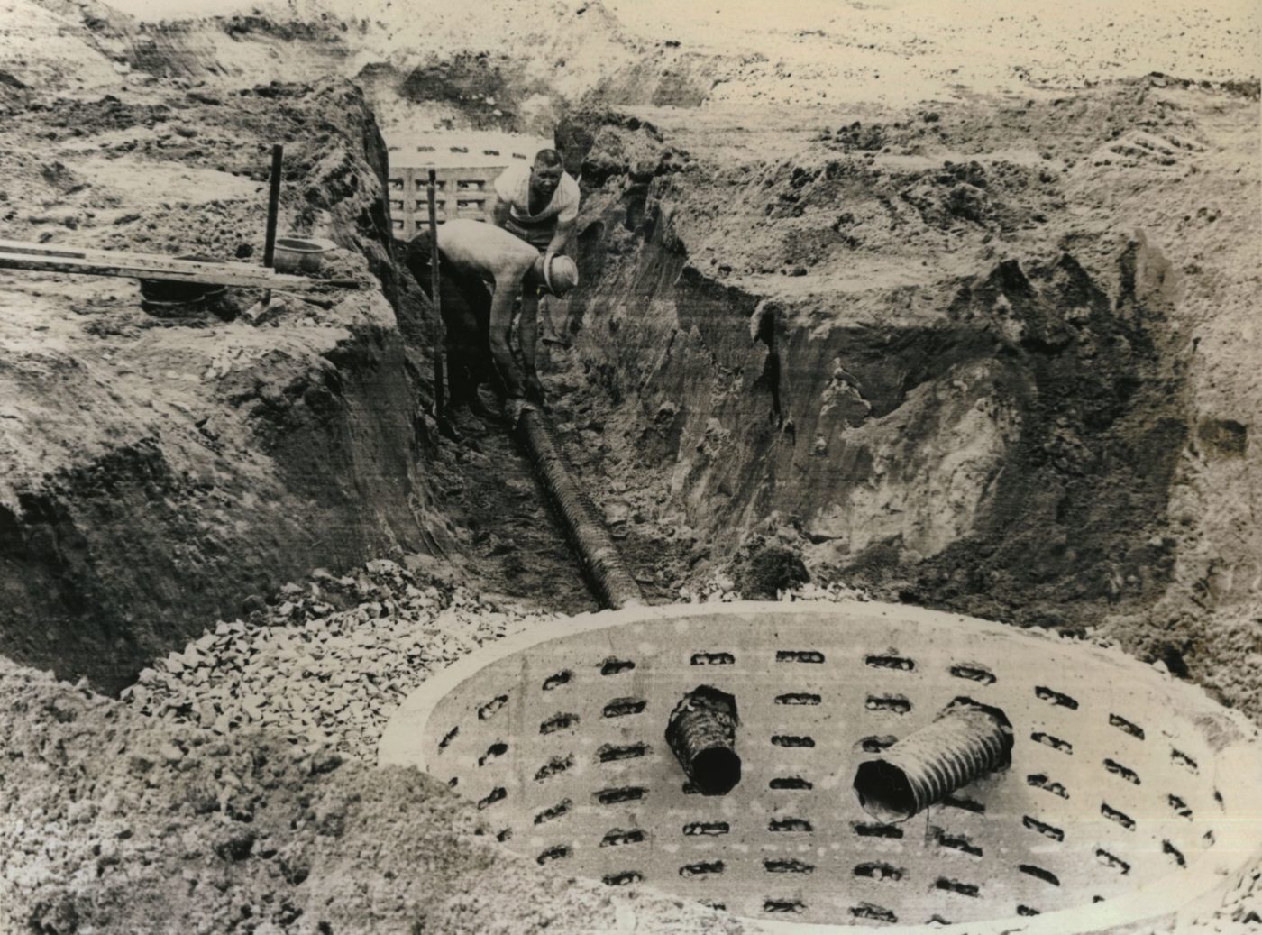 Workmen Installing Pipe In A Ditch In Glens Falls