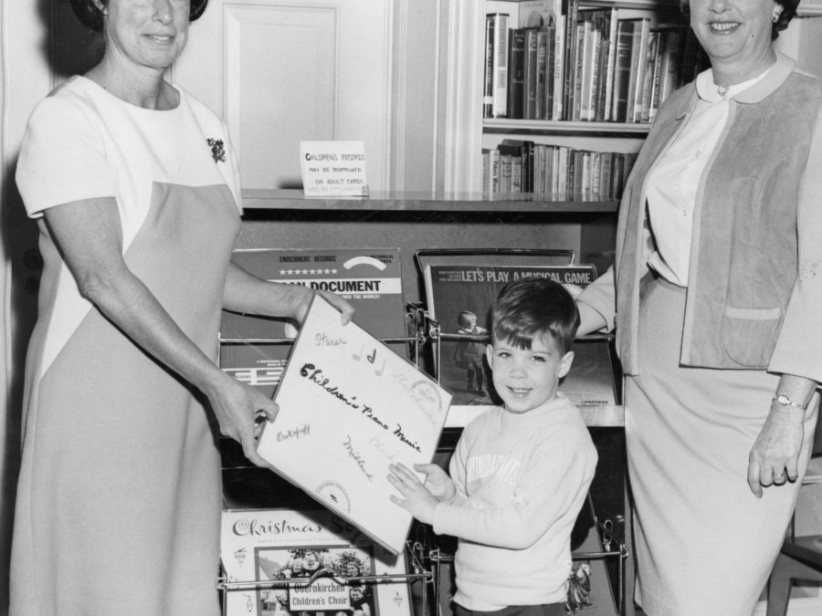 Reference Librarian and patron look through the card catalog at