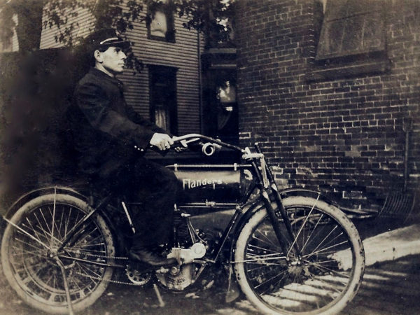 Firefighter Arthur Deline on a motorcycle in Watertown