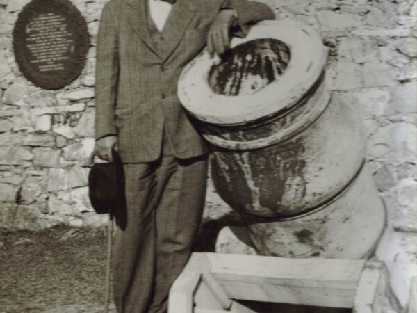 Stephen Hyatt Perlham Pell leans on a cannon during rebuilding of Fort Ticonderoga.