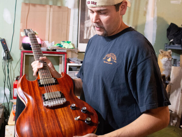 Glenn Hill holds guitar