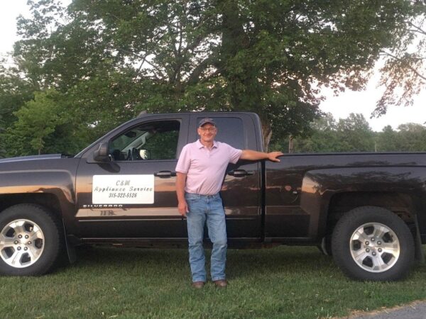 Chris Beldock in front of his work truck