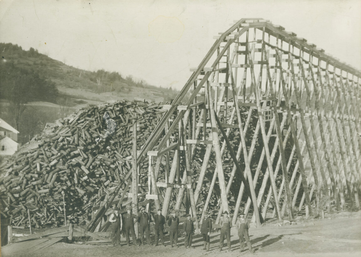 Workers with massive wood conveyor in Au Sable Forks