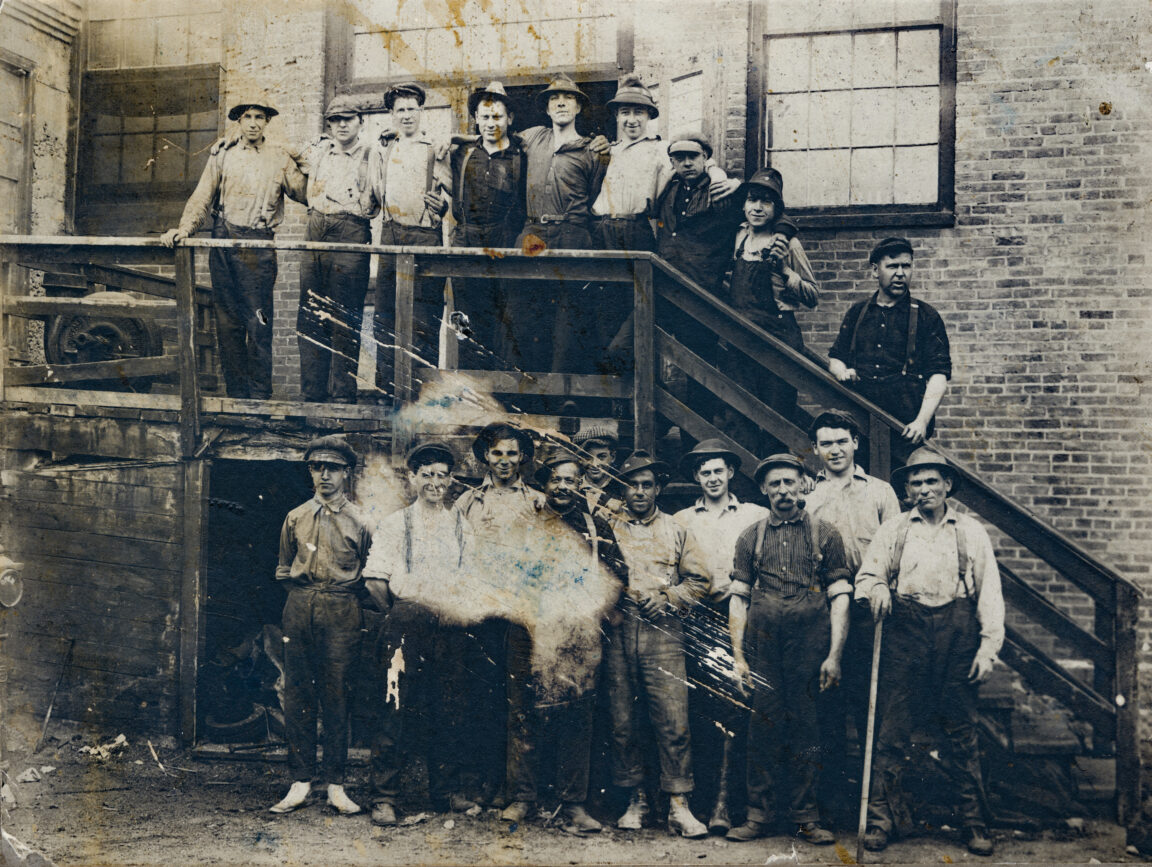 Workers on steps of pulp mill wet room in Au Sable Forks