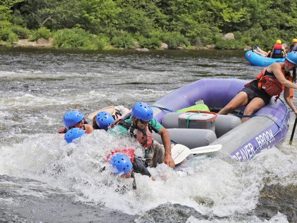 Whitewater raft with guide and passengers