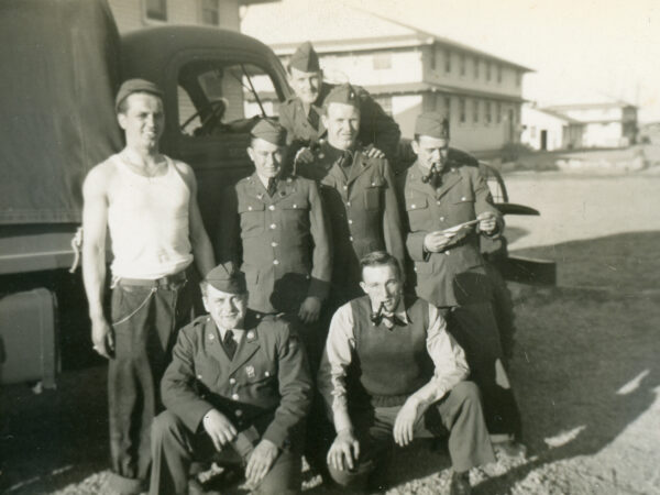 Soldiers pose in front of a truck