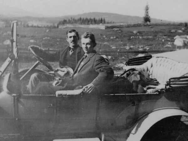 Two men in an early automobile